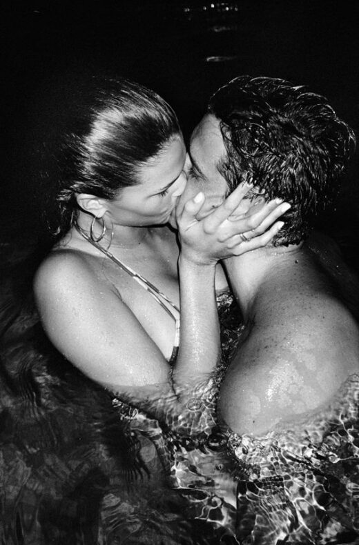 couple swimming and kissing
